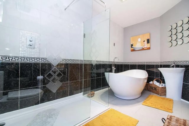 The stylish main family bathroom features stand alone bath.