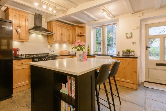 The kitchen has an island with breakfast bar, solid oak units and quartz worktops, with a dual fuel range cooker.