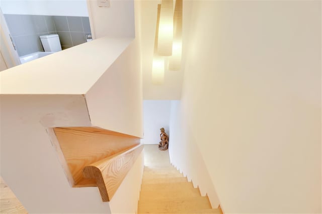 The birch ply staircase leads up from a corner in the lounge.