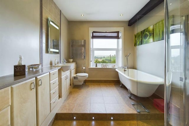 A spacious bathroom with free-standing bath.