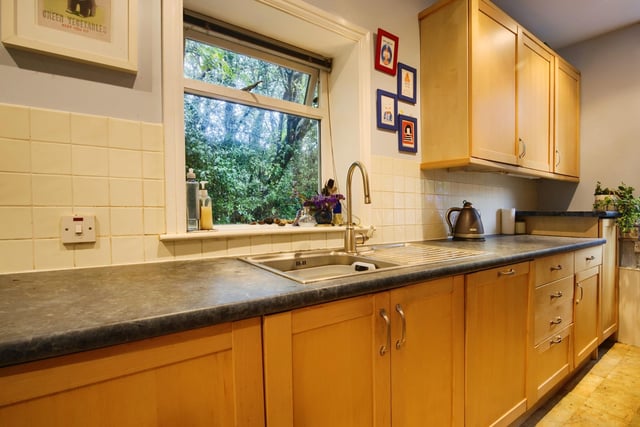 The kitchen, with fitted units, has double aspect windows.