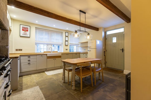 A beamed, farmhouse-style dining kitchen with plenty of space.
