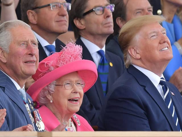 (L-R) Britain's Prince Charles, Prince of Wales, Britain's Queen Elizabeth II and US President Donald Trump look up as aircraft perform a fly-over during an event to commemorate the 75th anniversary of the D-Day landings, in Portsmouth, southern England, on June 5, 2019. - US President Donald Trump, Queen Elizabeth II and 300 veterans are to gather on the south coast of England on Wednesday for a poignant ceremony marking the 75th anniversary of D-Day. Other world leaders will join them in Portsmouth for Britain's national event to commemorate the Allied invasion of the Normandy beaches in France -- one of the turning points of World War II. (Photo by Daniel LEAL-OLIVAS / AFP)        (Photo credit should read DANIEL LEAL-OLIVAS/AFP/Getty Images)