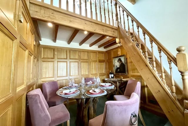 A dining area with oak wood-panelled walls.