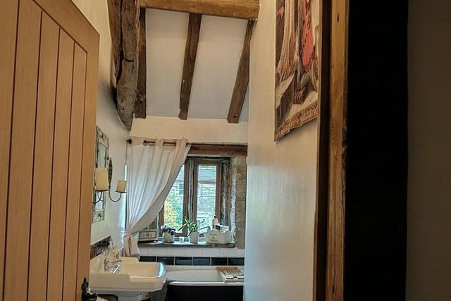 A glimpse of one of the cottage's beamed bathrooms.