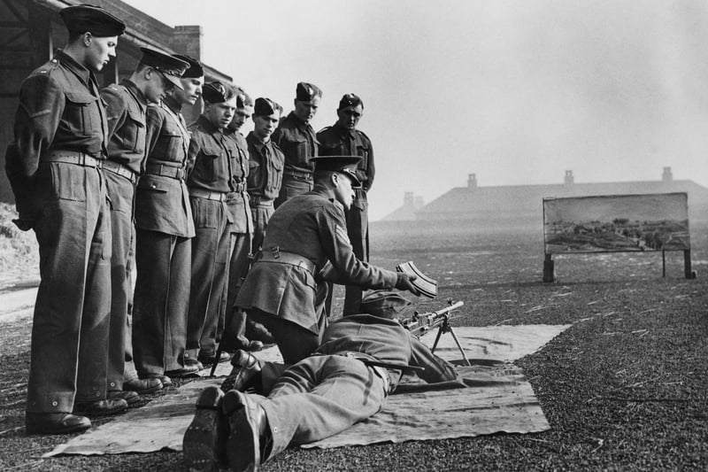 A sergeant of the Duke of Wellington's Regiment prepares to instruct new recruits on how to use the Royal Small Arms Factory Bren .303 light machine gun by firing at a painted cardboard dummy target at their depot on 5 March 1940 in Halifax