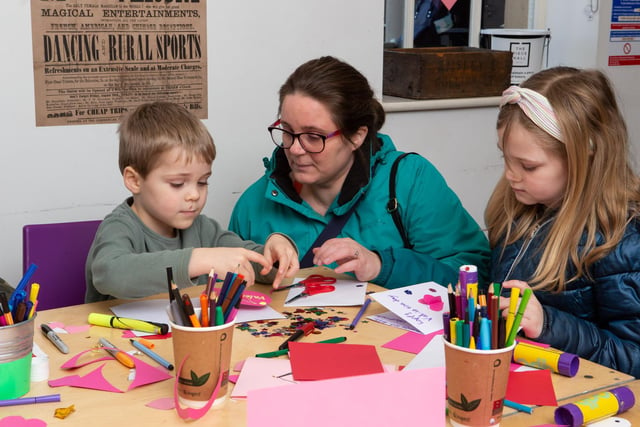 Valentine's Day card marking and crafts event at The Piece Hall, Halifax. Pictured are Elijah and Freya Burgin with help from mum Emily Burgin