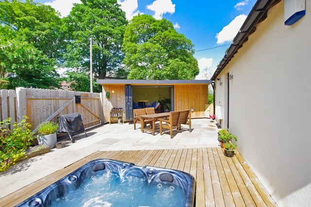 An area of decking holds the sunken hot tub, with far reaching views.