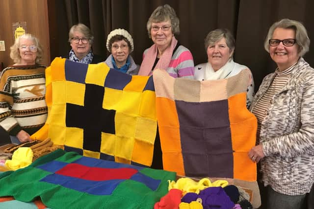 St. Andrew’s Methodist Church Knit & Natter Group, Halifax, holding their quilts.