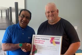 Mohammed Daji, Resident Engagement Officer, gives Justin Appleyard Tpas Engagement Heroes Volunteer Recognition certificate