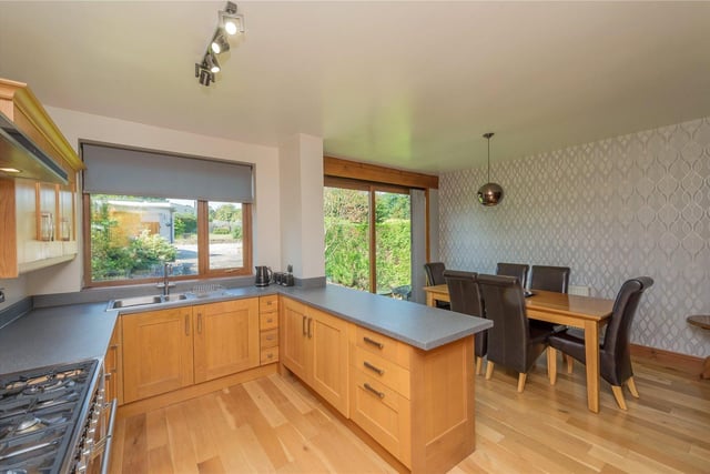 The kitchen has fitted oak units with integrated appliances, while the dining area has uPVC patio doors leading outside.