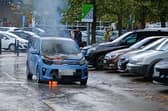The car on fire in the car park of Sainsbury's in Halifax