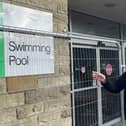 Coun Steven Leigh outside the fenced-off old Halifax Swimming Pool building at Skircoat Road – he is urging Calderdale Council not to demolish it but consider refurbishment, in light of the pausing of building a proposed new leisure centre