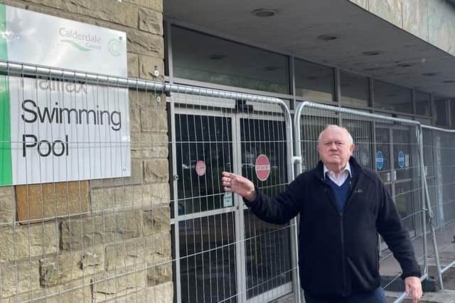 Coun Steven Leigh outside the fenced-off old Halifax Swimming Pool building at Skircoat Road – he is urging Calderdale Council not to demolish it but consider refurbishment, in light of the pausing of building a proposed new leisure centre
