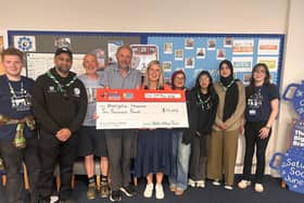 Andrew Bibby (centre left) with Tracey Wilcocks (CEO, Overgate Hospice, right centre). With them are others who helped make the race possible, including members of the 51st Pellon Scout group.