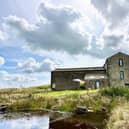 View of the farmhouse in its stunning rural and moorland setting.