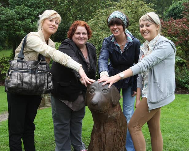 TV presenter Dawn Porter with Gemma Rowbottom , Sally Darlington and Kendall Rowbottom pat the head of the lucky dog in Centre Vale Park, Todmorden.
