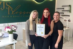 Zara (centre) with the salon's finalist certificate as part of the Hair and Beauty Awards 2026.