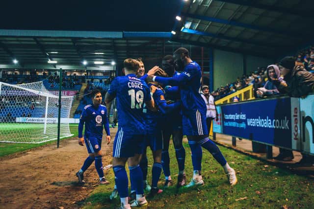 Town celebrate a goal in their home win over Dorking, which took them to the verge of the play-off places
