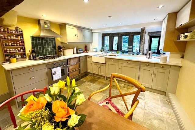 A spacious beamed dining kitchen with fitted units and spotlight.