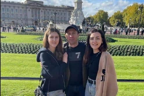 Olga Fedchenko (right) with husband Sergiy and daughter Polina on a trip to Buckingham Palace in London.