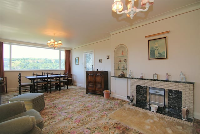 The lounge stretches from front to back, with a large picture window displaying the valley views.