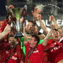 WREXHAM, WALES - APRIL 22: Ben Tozer and Luke Young of Wrexham lift the Vanarama National League trophy as Wrexham win the Vanarama National League and are promoted to the English Football League after victory in the Vanarama National League match between Wrexham and Boreham Wood at Racecourse Ground on April 22, 2023 in Wrexham, Wales. (Photo by Jan Kruger/Getty Images)