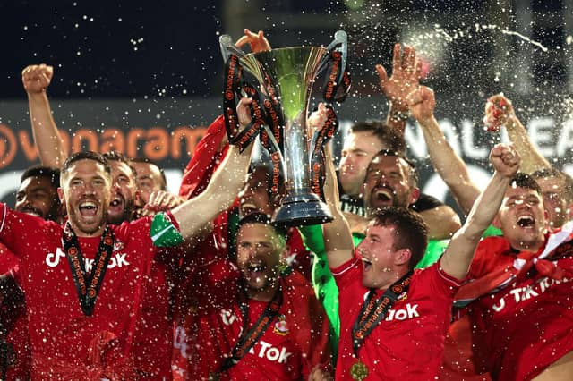 WREXHAM, WALES - APRIL 22: Ben Tozer and Luke Young of Wrexham lift the Vanarama National League trophy as Wrexham win the Vanarama National League and are promoted to the English Football League after victory in the Vanarama National League match between Wrexham and Boreham Wood at Racecourse Ground on April 22, 2023 in Wrexham, Wales. (Photo by Jan Kruger/Getty Images)