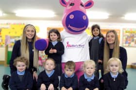 Millie Giraffe, the mascot for Millie’s Mark, with the nursery's deputy managers Lauren Knight (left) and Alice Imeson (right) and children from the pre-school room.