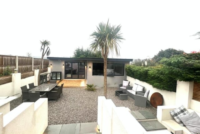 A rear view of the property, towards the garden room with fitted bar and further facilities.