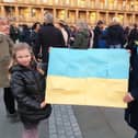 Tetyana Lyuta and her daughter with a Ukrainian flag they made for the Stand with the Ukraine event at The Piece Hall