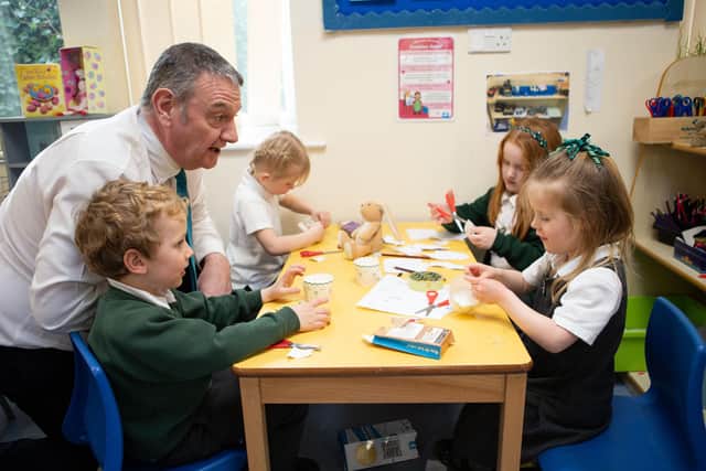 Good Ofsted report for Triangle C of E Primary School. Pictured is head teacher Gavin Davies with pupils