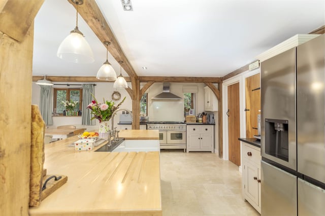 The light and spacious, open plan fitted kitchen with island.