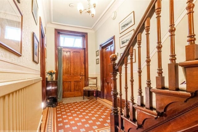 A traditional tiled floor, heated from beneath, and a carved wood staircase in the hall make a grand first impression.