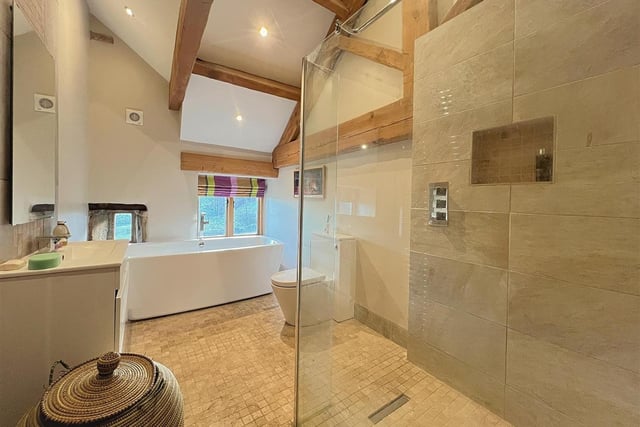 A spacious bathroom with vaulted ceiling.