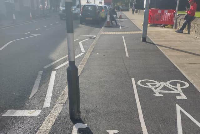 The new cycle lane at King Cross, Halifax, with a pedestrian crossing post and a lamp-post in the middle has been criticised.