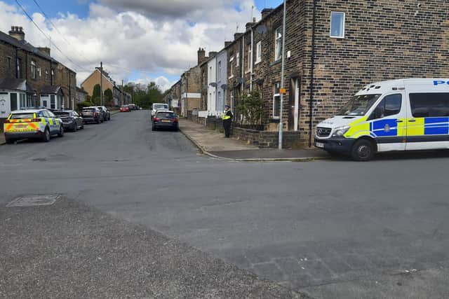 Police on Woodside View in Boothtown, Halifax, today