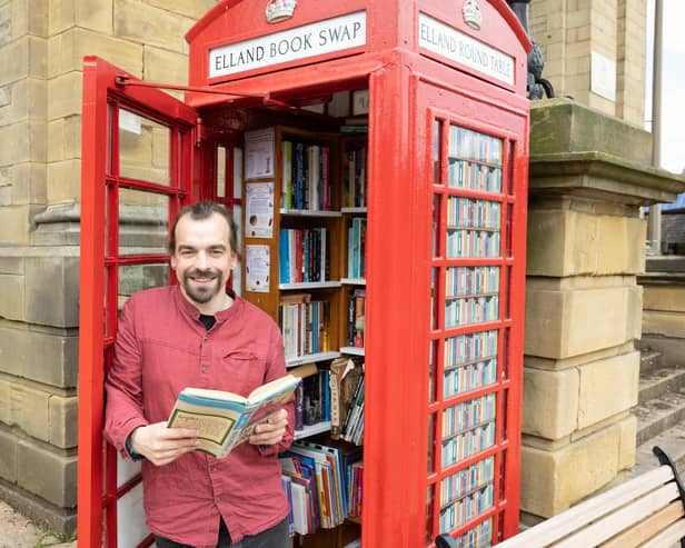 Dave Needham at the Elland book swap phonebox, on it's first anniversary