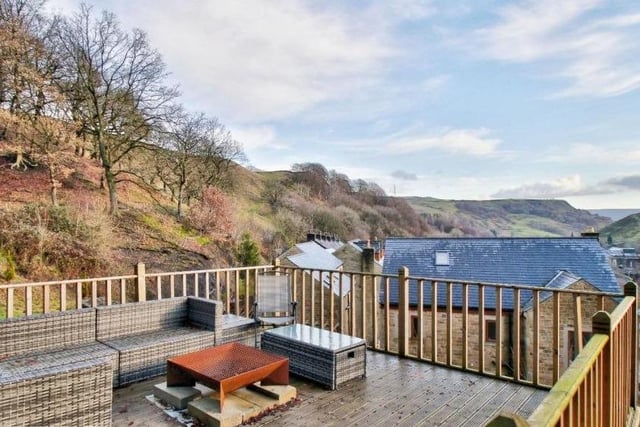 This decked seating area has commanding views from its hillside location.
