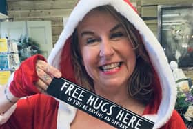 Mandy Wilson from Manjo Home in Halifax's Piece Hall is giving away free hugs
