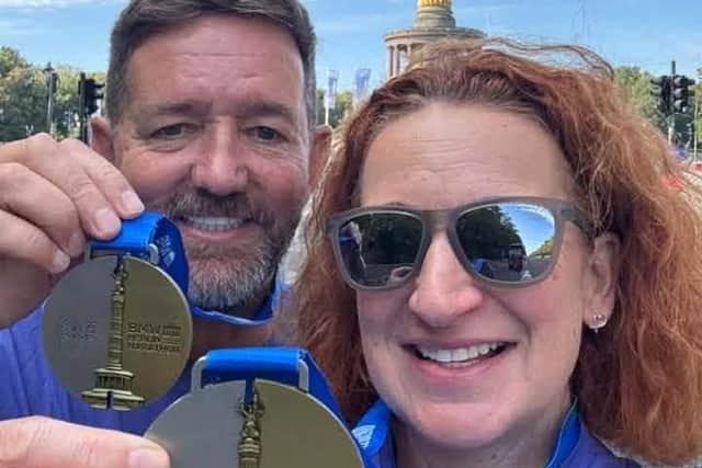 Mike Farrell and Dawn Higgins show off their Berlin Marathon medals.