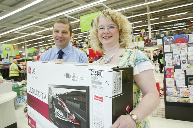 General store manager Karl Brown and Euro Prediction Game competition winner Amanda Thomas with her 50 inch plasma TV prize, at Halifax Asda.