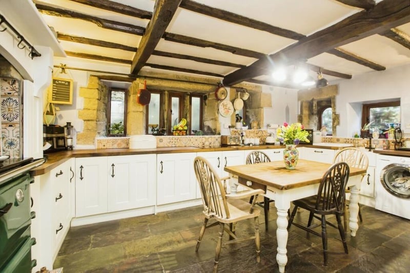 The bright breakfast kitchen has fitted units and integrated appliances, plus an Aga.