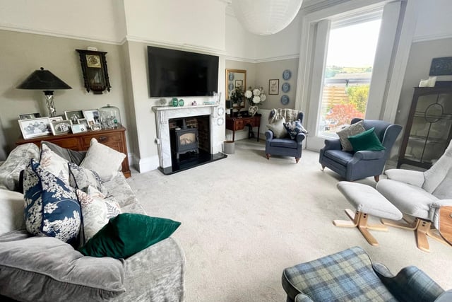 The lounge features a marble fireplace with a living flame gas stove