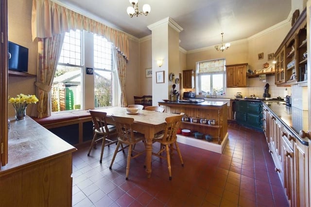 The kitchen with diner has solid wooden units with granite worktops. The deep sills of the sash windows provide seating.