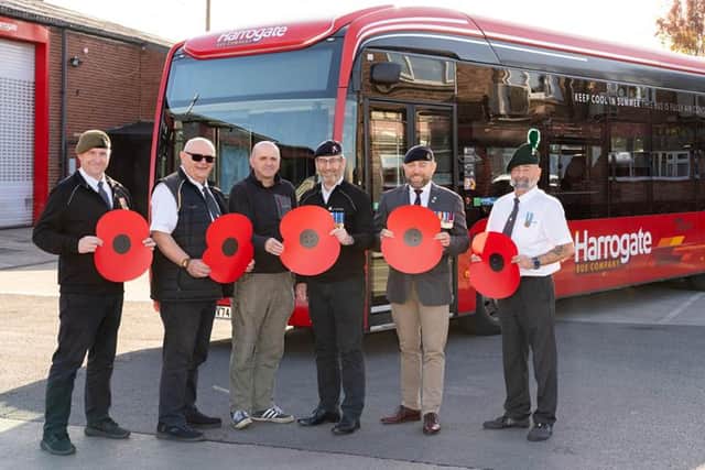 Transdev colleagues who are former Armed Forces personnel with poppies in front of a bus, operated by Transdev, for the Poppy Appeal 2026 campaign renewal.