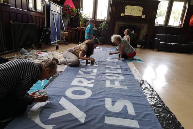 Calderdale XR activists paint banner for upcoming protest. Picture: XR Photographers