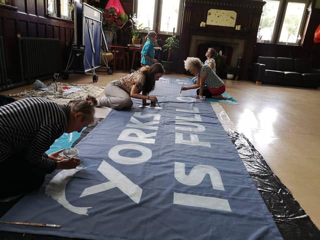 Calderdale XR activists paint banner for upcoming protest. Picture: XR Photographers