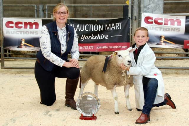 Charlie Leach with his Skipton young handlers title winner, joined by show judge Annabel Mason. Picture: Moule Media, Skipton