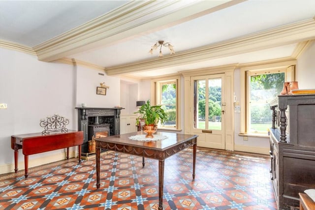 The entrance hall into the property features a tiled floor and a wood-burning stove.